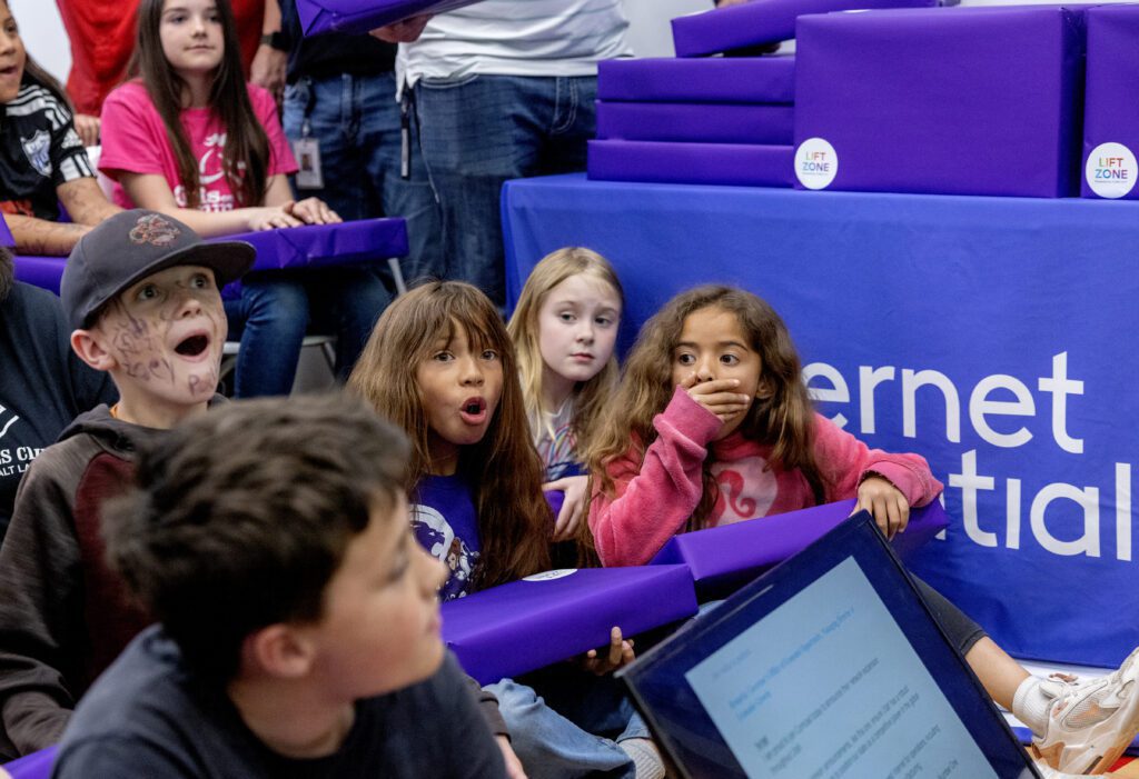 Kids from the Tooele Boys & Girls Club react to being given laptops during a Lift Zone Technology Center Ribbon Cutting ceremony at the Boys & Girls Club of Greater Salt Lake on Wednesday, May 22, 2024 in Tooele, UT.